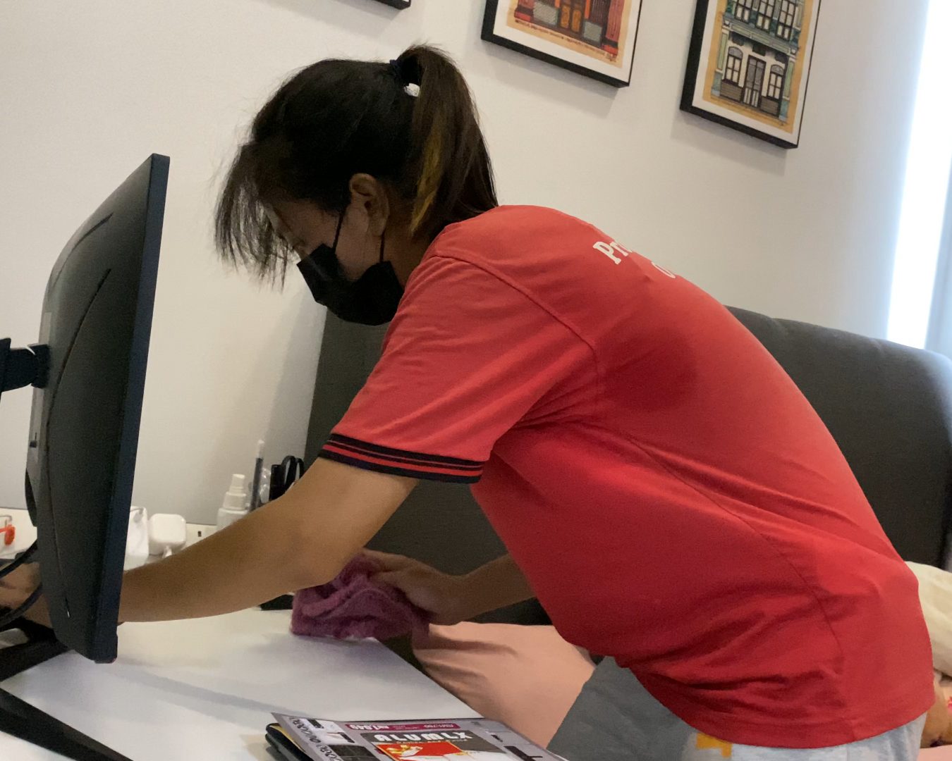 Ultra Cleaning specialist in uniform wiping an office desk